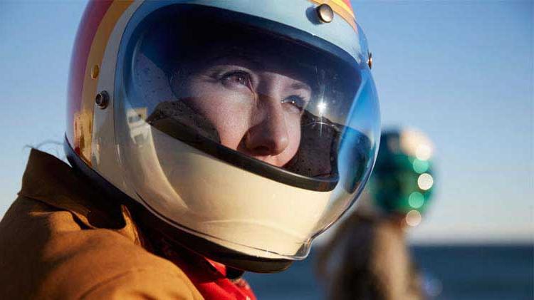 Woman wearing a motorcycle helmet.
